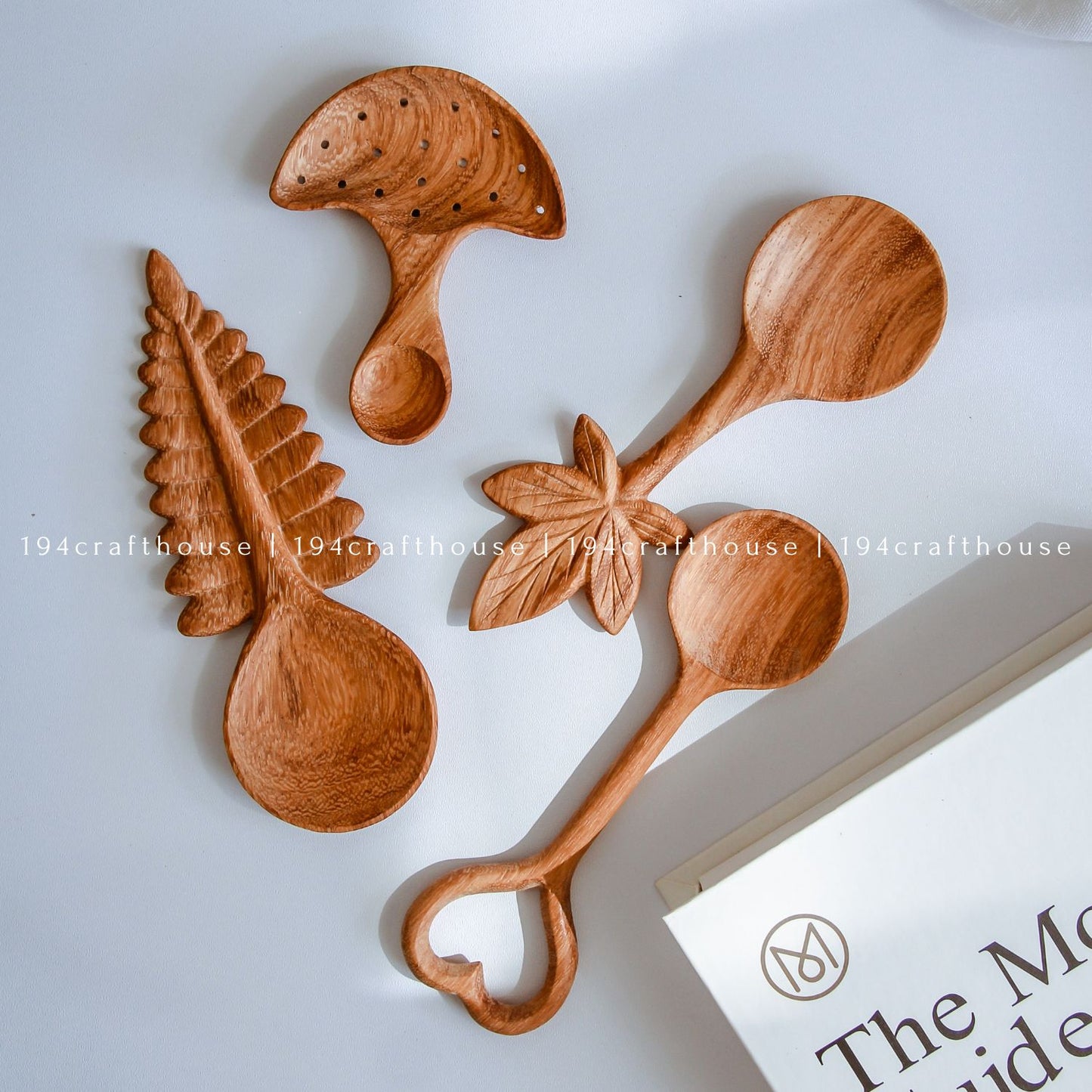 Collection of wooden spoons with unique designs on a white background, handcrafted cottagecore kitchen utensils and decor by 194 Craft House.