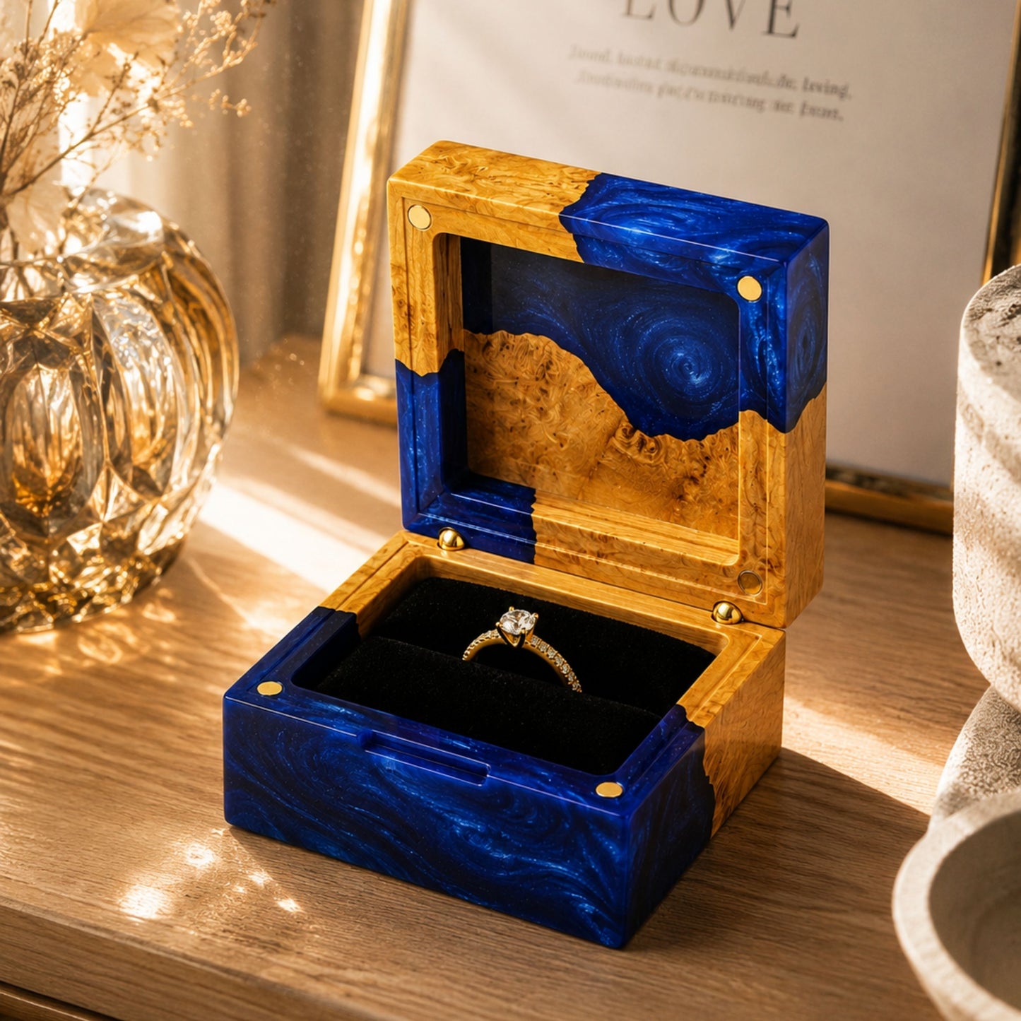 Open blue resin and natural burl wood engagement ring box holding a diamond ring on a rustic wooden table.