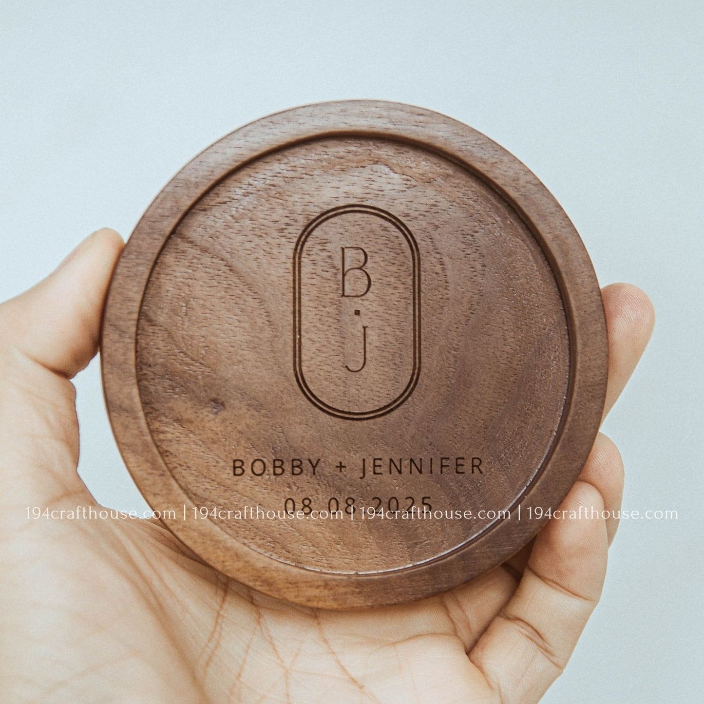 Round walnut wood coaster with personalized engraving and natural handcrafted wood grain