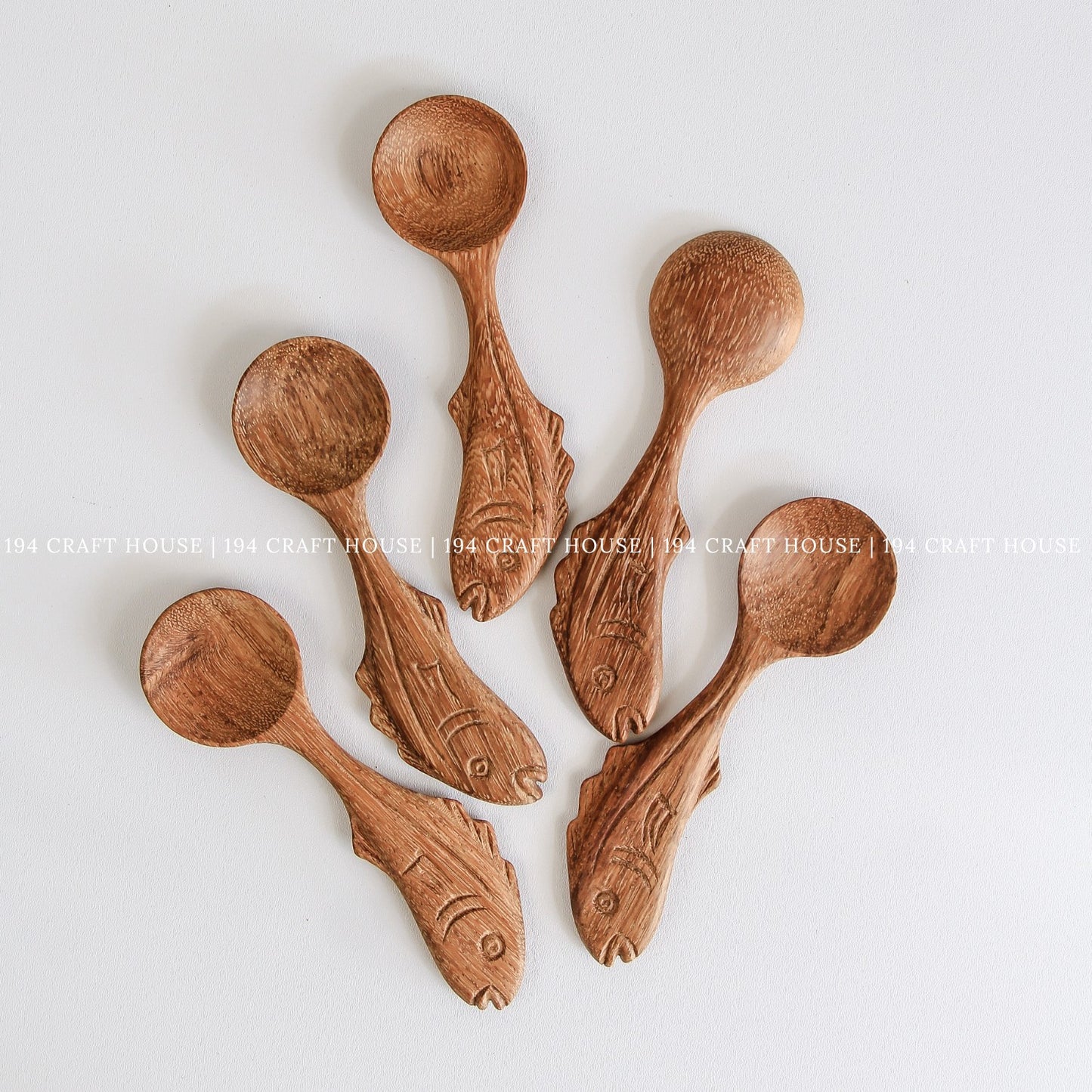 Set of handcrafted fish-shaped wooden measuring spoons with beautiful natural wood grain