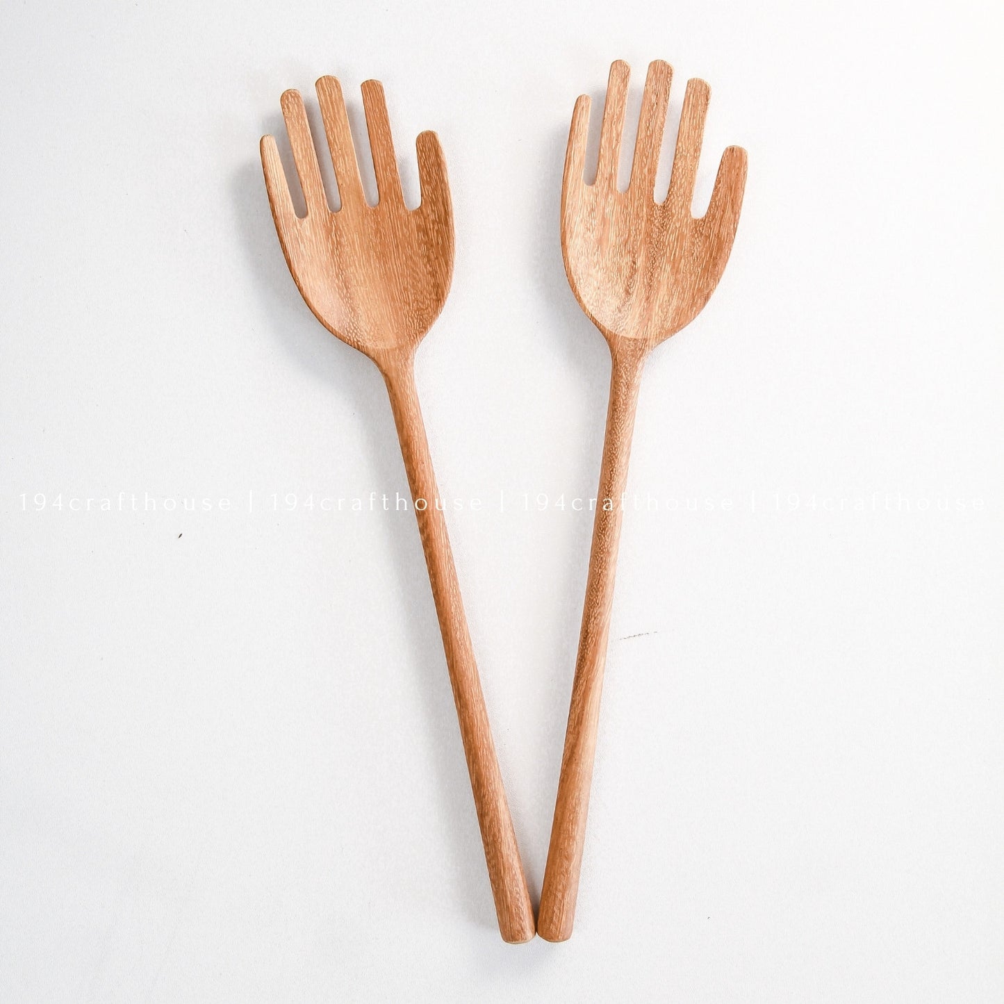 Pair of handcrafted hand-shaped wooden salad servers for tossing and serving