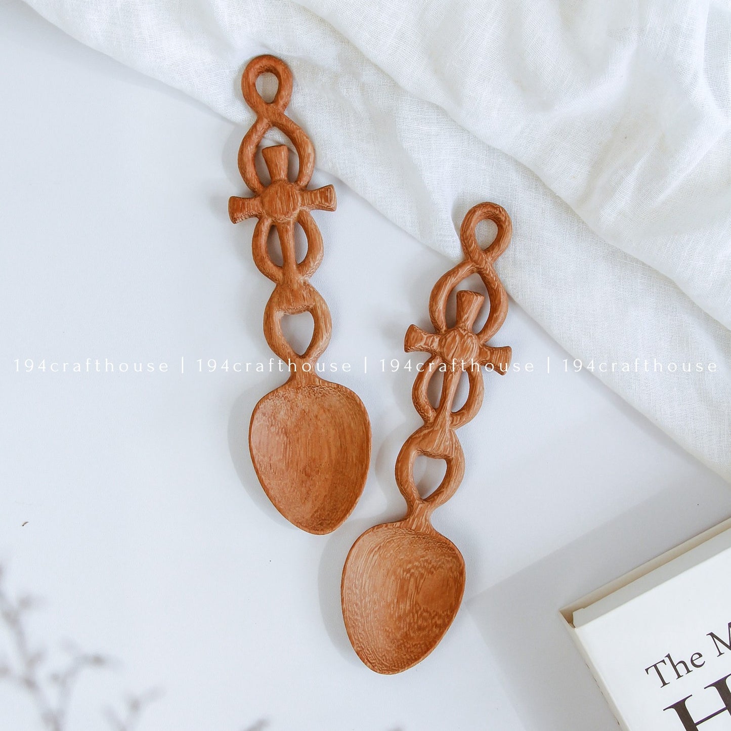 Hand-carved Doussie wood Celtic Cross Welsh love spoon resting on a white background, handcrafted by 194 Craft House.