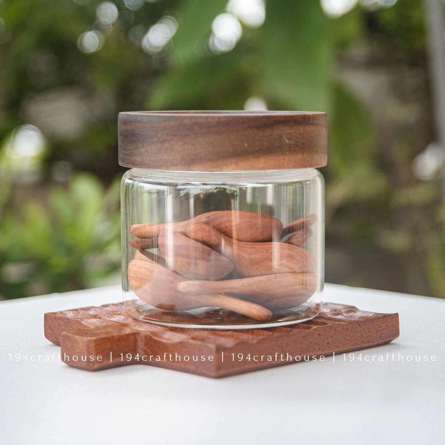 Mini wooden spoons displayed with glass jars for spices, sugar, salt, tea, and coffee