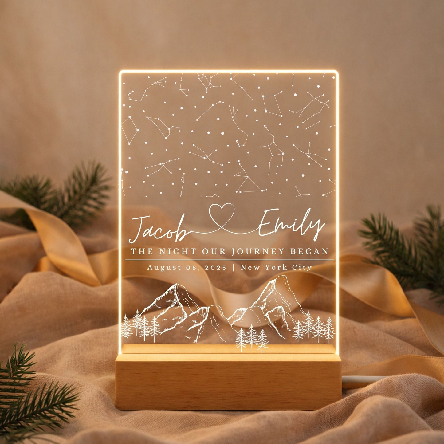 Acrylic star map lamp glowing with warm white light, highlighting custom names and a significant date.