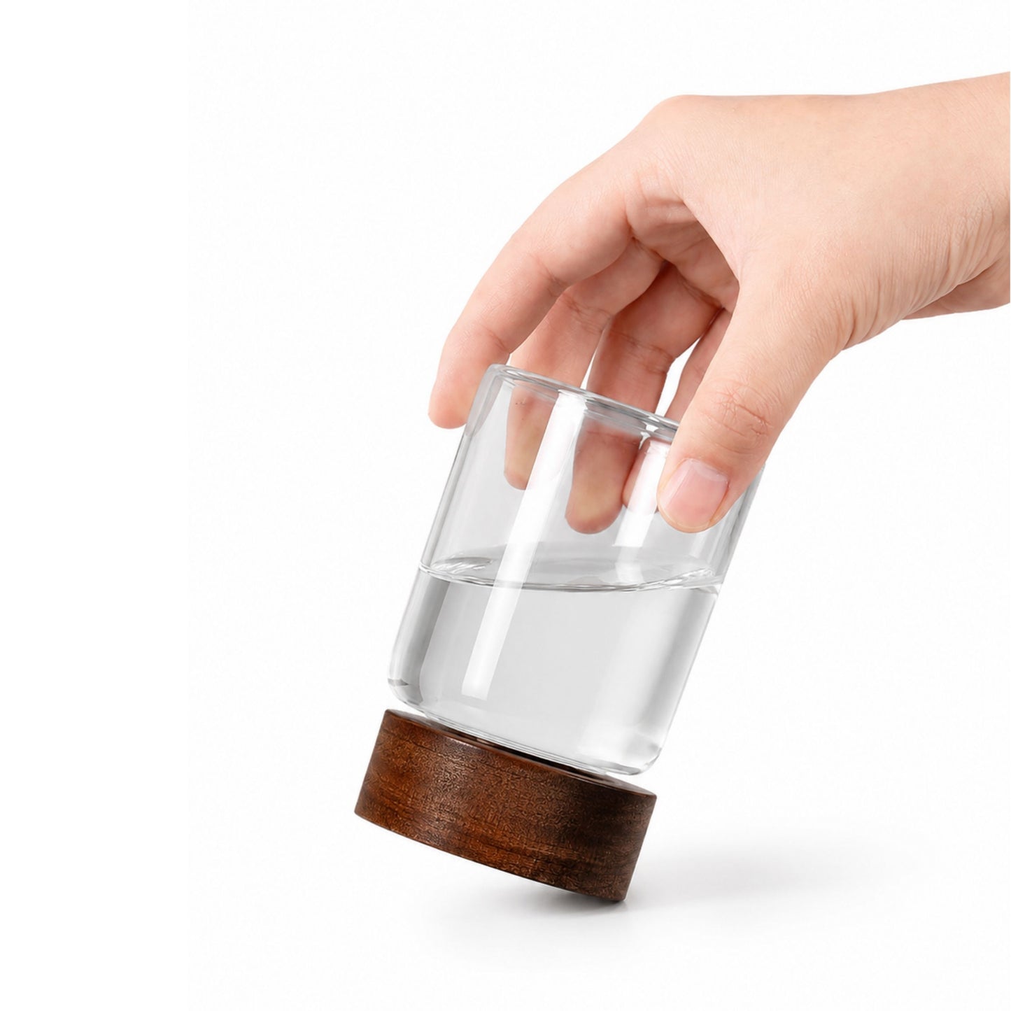 Close-up of a hand opening a clear glass food jar, demonstrating the functional airtight wooden lid and seal.