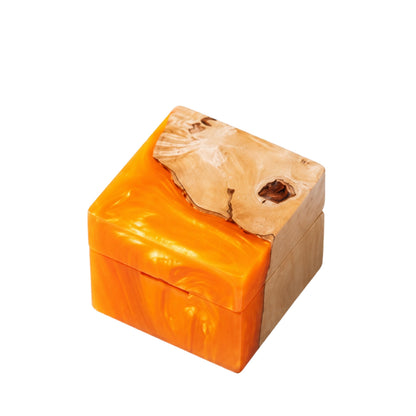 Square artisan wedding ring box made of orange epoxy resin and natural burl wood.