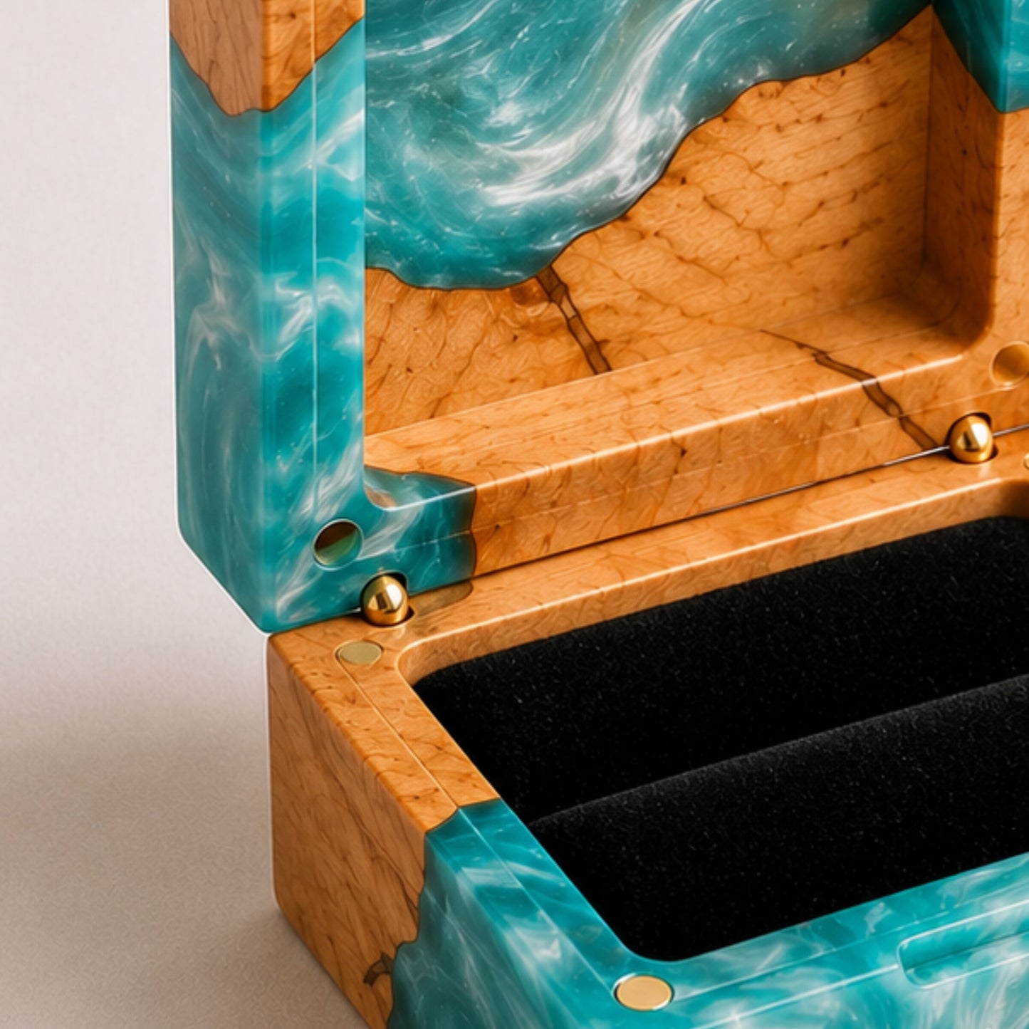 Close-up of an open square ring box made of turquoise resin and burl wood with a black velvet interior and magnet closure.