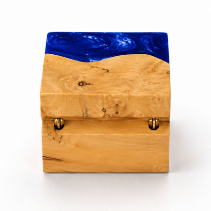 Hinge side back view of a square handcrafted ring box made of blue resin and natural burl wood.