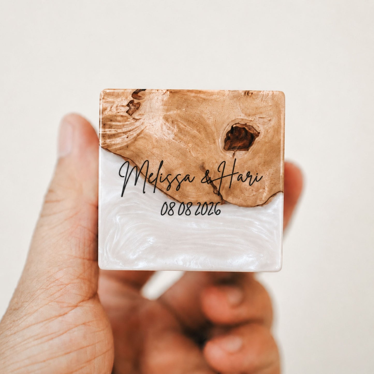 Custom engraved artisan ring box made of white epoxy resin and wood, showcasing a personalized name and date engraving