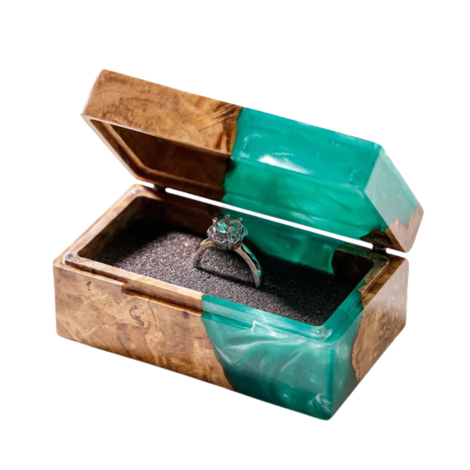 Open handcrafted wood and turquoise epoxy resin engagement ring box displaying a proposal diamond ring inside a black velvet slot.
