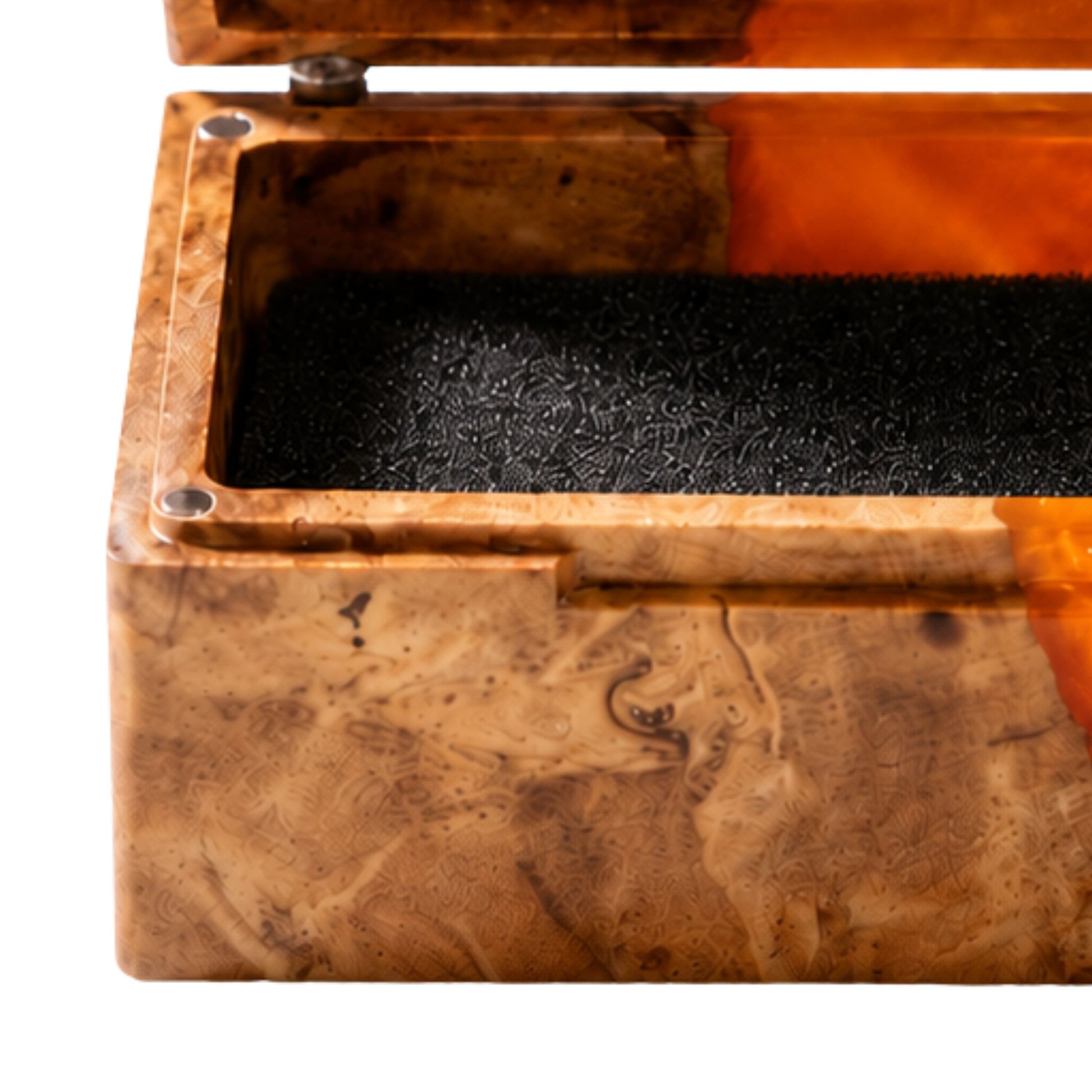 Close-up shot of an engagement ring cushioned inside an open burl wood and orange epoxy resin ring box.
