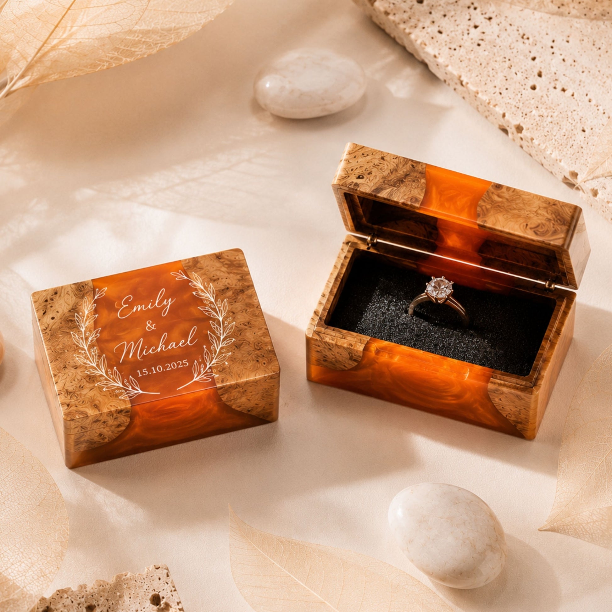 Pair of custom engraved wood and orange resin ring boxes set on a wedding styled table
