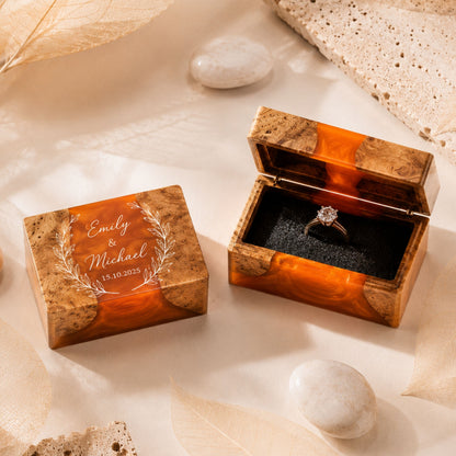 Pair of custom engraved wood and orange resin ring boxes set on a wedding styled table
