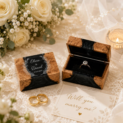 Pair of custom engraved wood and black resin ring boxes set on a wedding styled table
