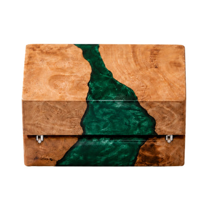 Back view of a closed wood and emerald green epoxy resin ring box showing the gold metal hinges and natural wood grain texture.
