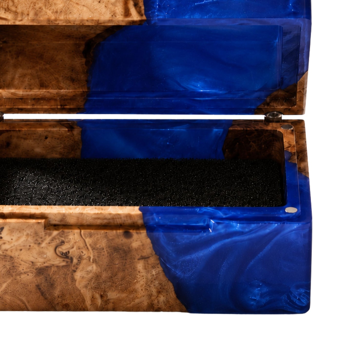 Close-up shot of an engagement ring cushioned inside an open burl wood and blue epoxy resin ring box.
