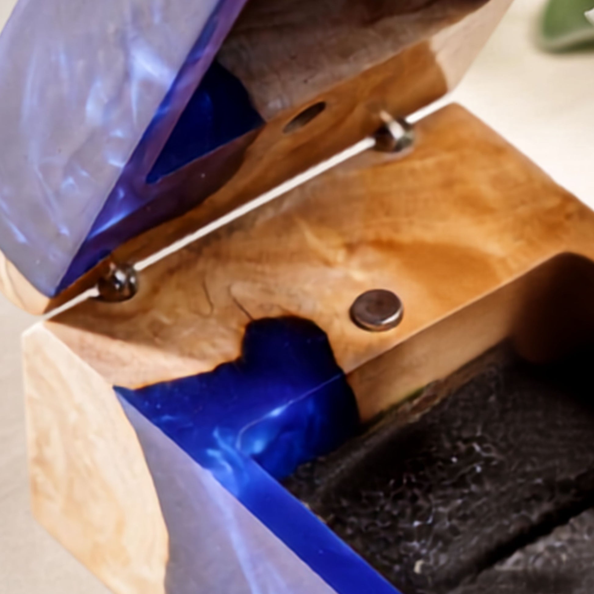Close-up top view showing the magnet and interior layout of a wood resin ring box.