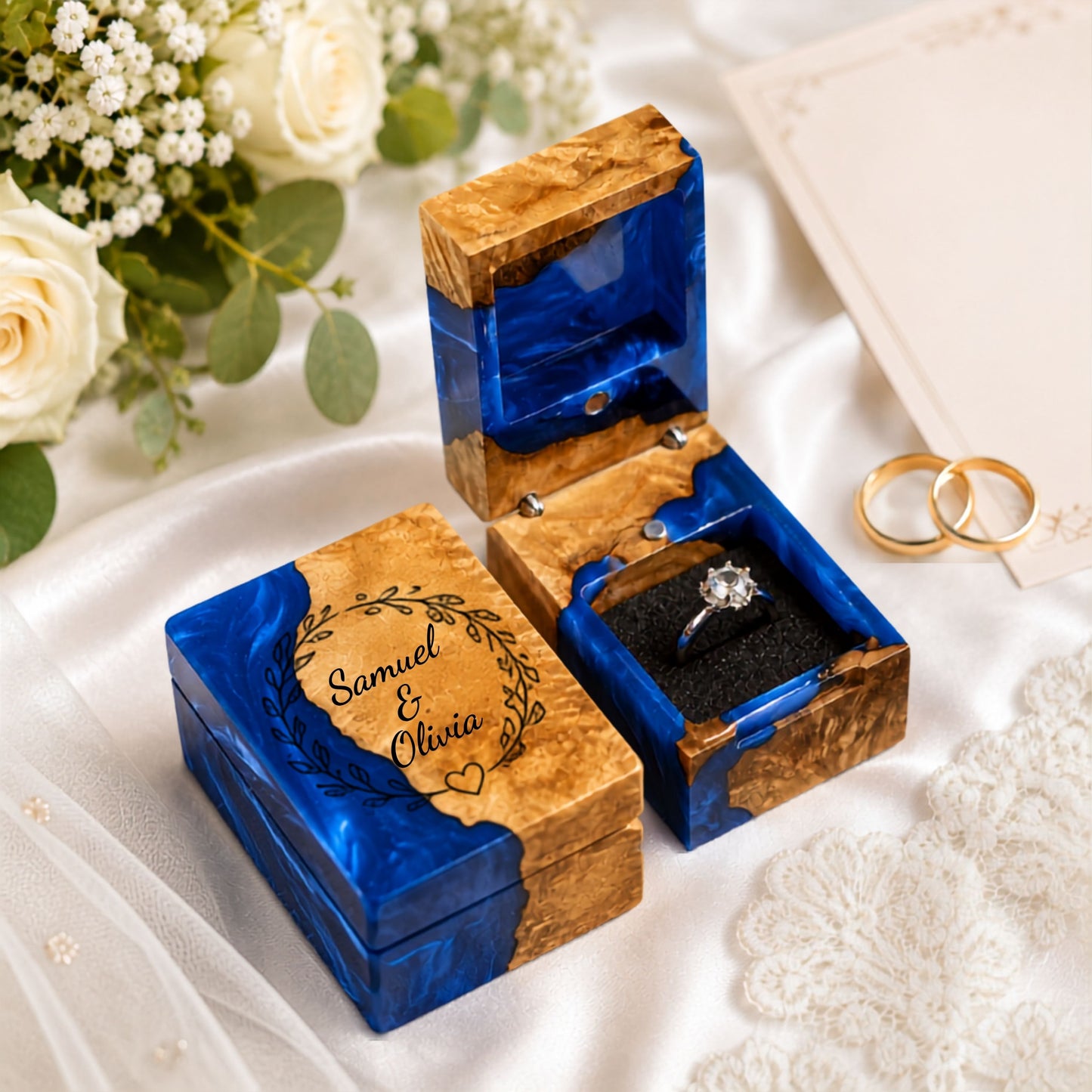 Personalized wooden and blue resin ring box engraved with couple names for a wedding proposal.