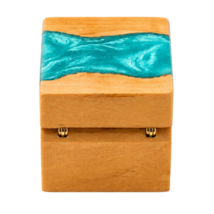 Back view of a wooden ring box featuring gold hinges and a turquoise resin river design across the top lid.