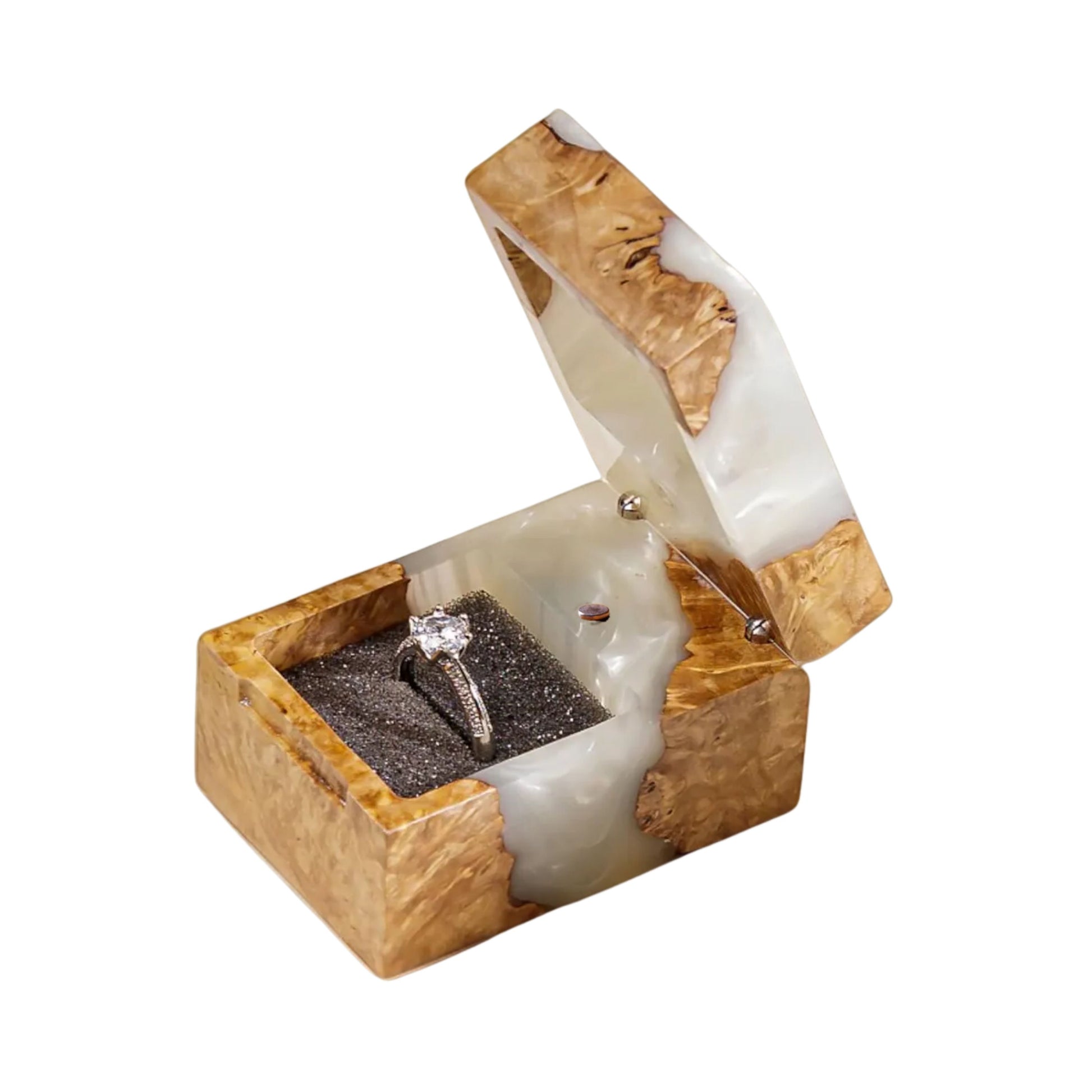 Open pearl white epoxy resin and natural wood ring box holding a diamond engagement ring in a black interior slot.