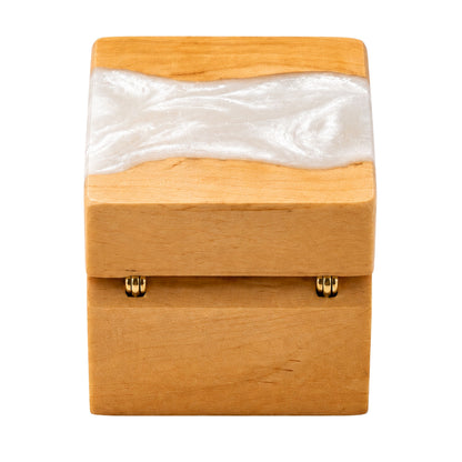 Back view of a wooden ring box featuring gold hinges and a pearl white resin river design across the top lid.