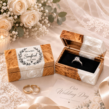 Pair of custom engraved wood and white pearl resin ring boxes set on a wedding styled table
