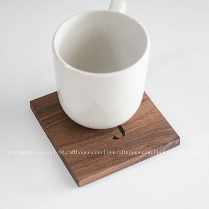 White coffee mug displayed on a handcrafted square