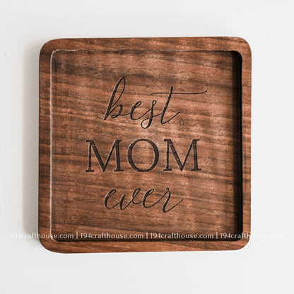 Top-down view of a Best Mom Ever engraved on a single square hand-carved walnut wood coaster with smooth rounded corners on a clean white surface by 194 Craft House