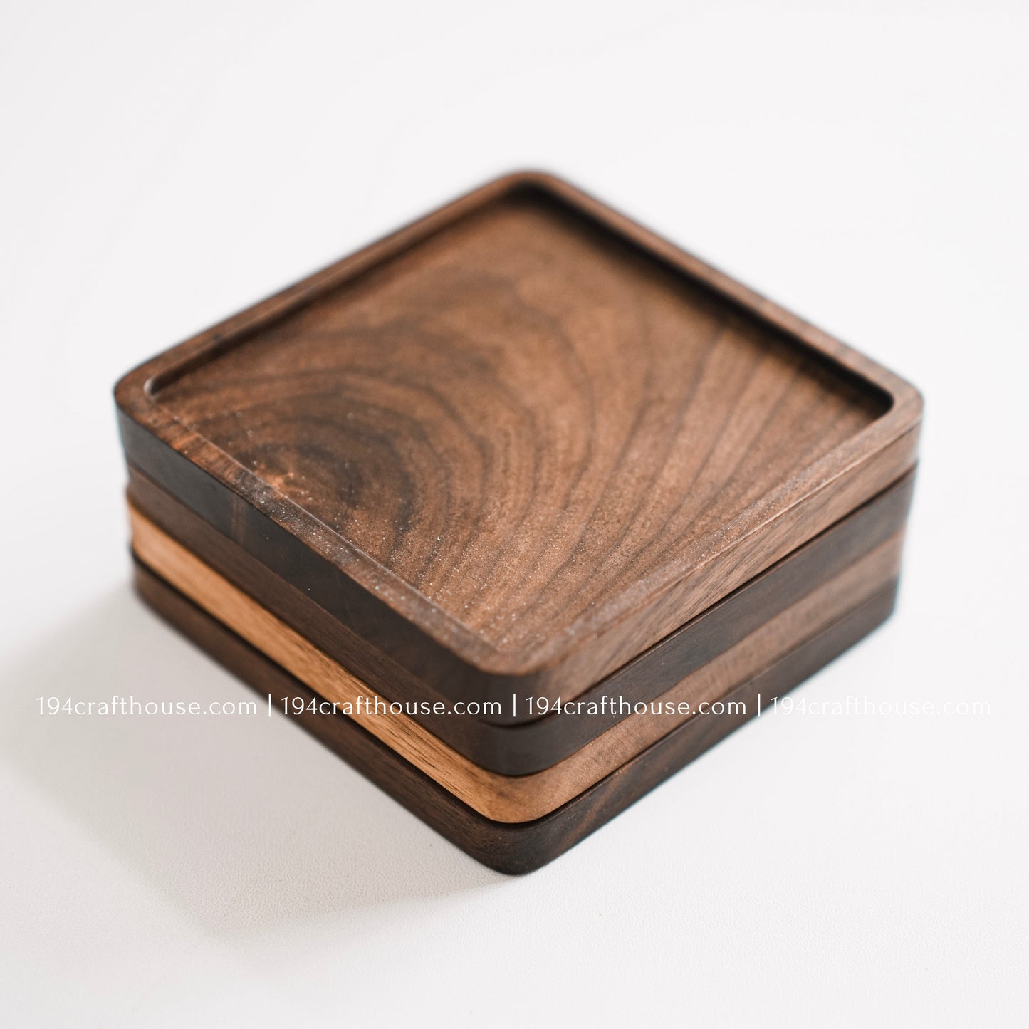Single handcrafted square walnut wood coaster featuring rich natural grain and rounded corners