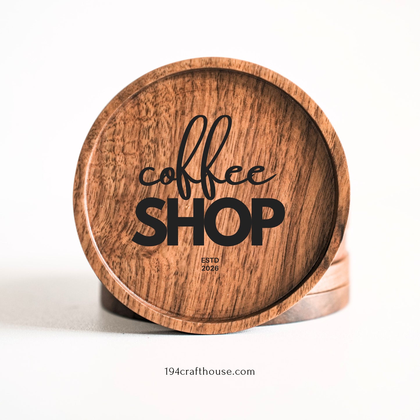 A round wooden coaster with a natural wood grain finish, featuring the words 'coffee SHOP' in black lettering, displayed on a clean white background.