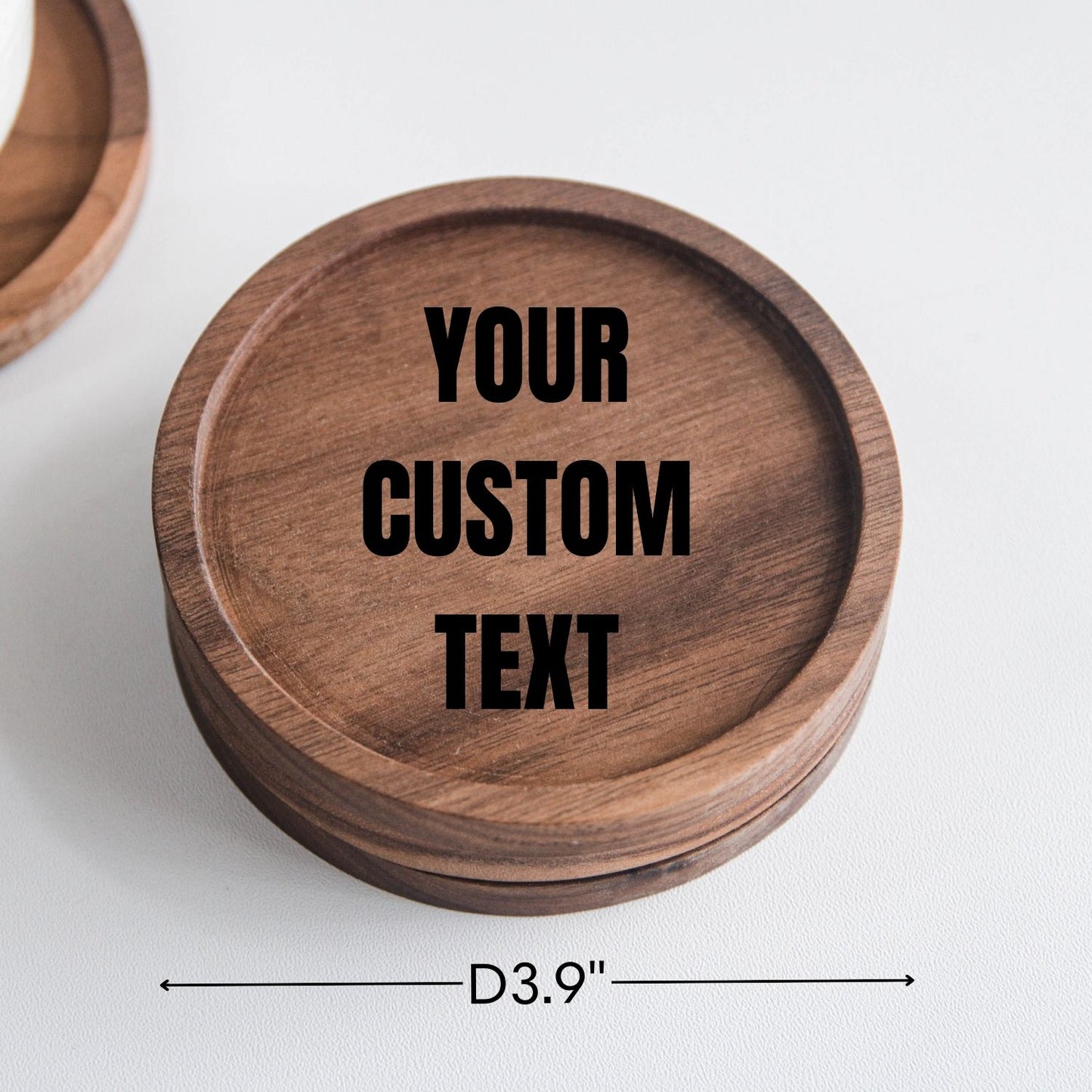 Custom text engraved on a round walnut wood coaster with a smooth handcrafted finish