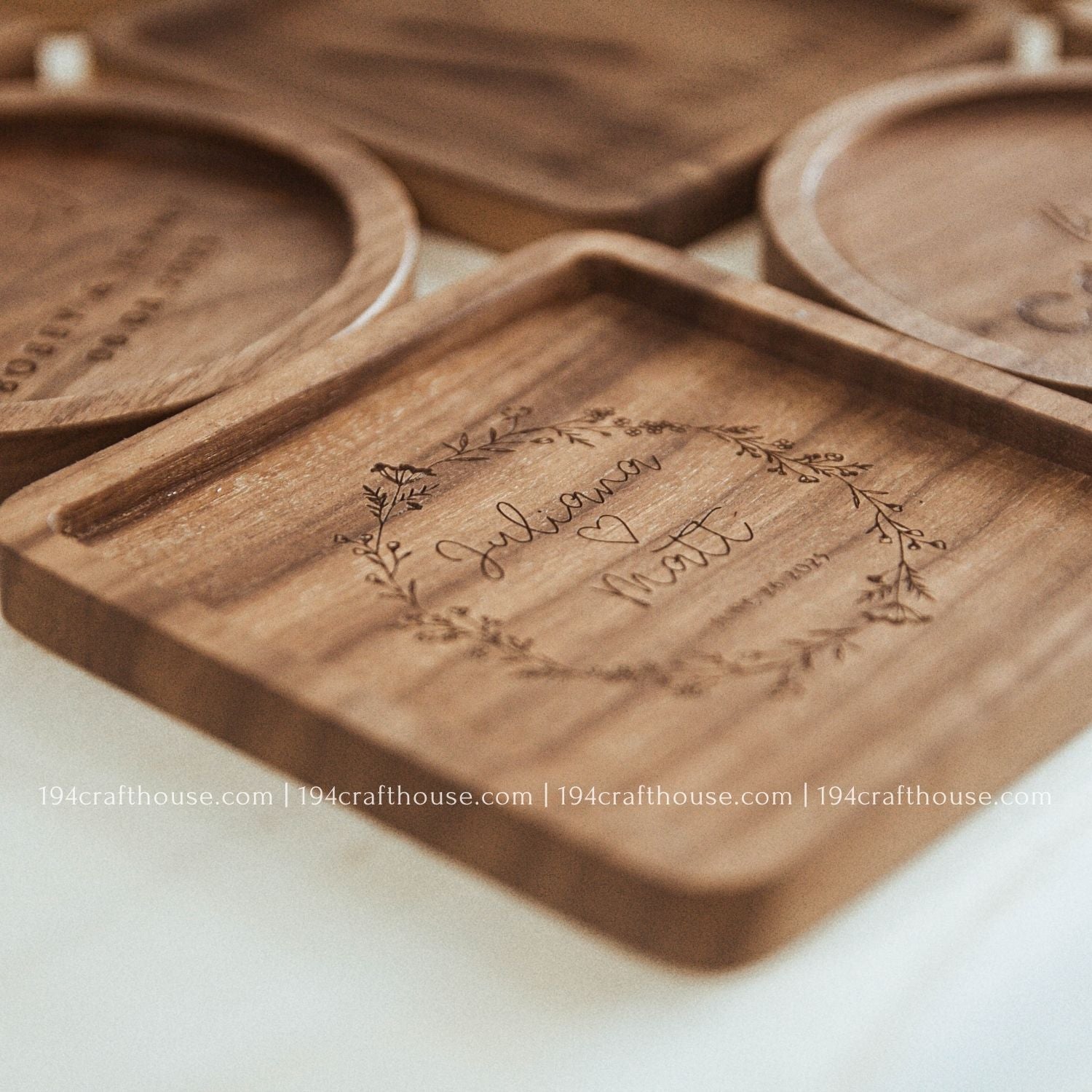 Set of handcrafted walnut wood coasters featuring custom engraving and unique natural grain