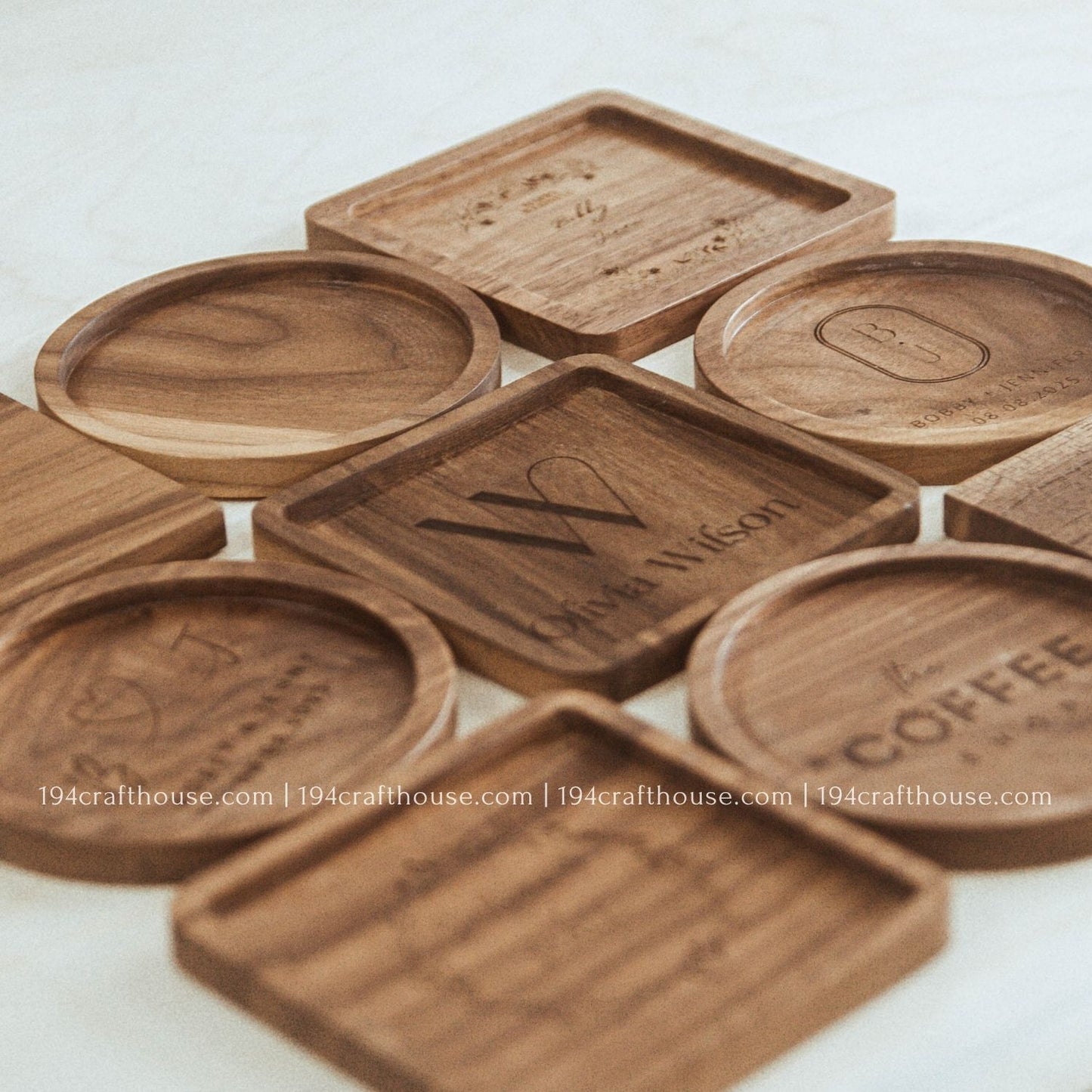 Personalized walnut wood coasters with custom engraved designs and natural wood grain