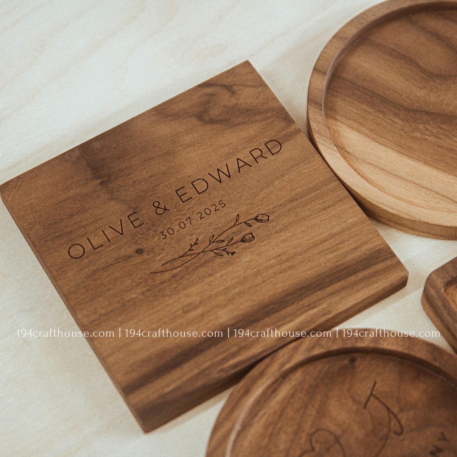 Wooden coaster set with engraved text on a light background