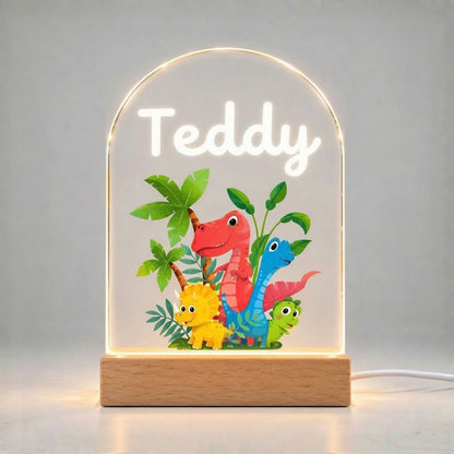 Illuminated arched panel displays the name Teddy above a colorful group of dinosaurs