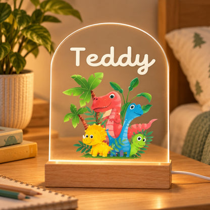 Glowing rounded night light with Teddy's name and colorful dinosaurs on a bedside table