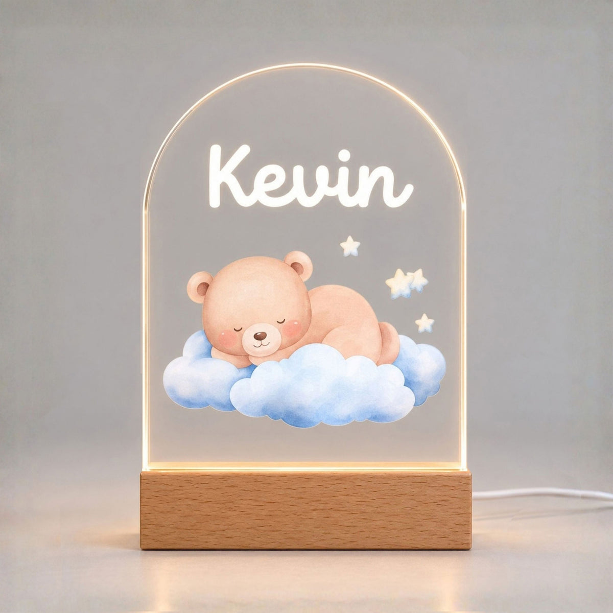 Glowing arched night light displays Kevin and a sleeping bear on blue clouds with stars.