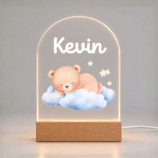 Glowing arched night light displays Kevin and a sleeping bear on blue clouds with stars.