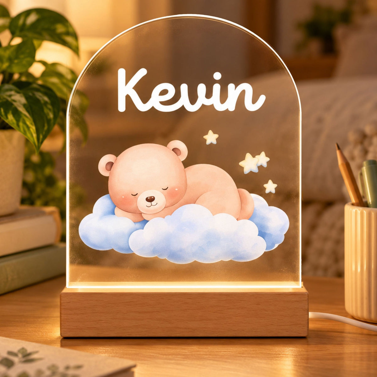 Arched acrylic night light with Kevin above a sleeping bear on blue clouds, glowing on a wood-tone base.