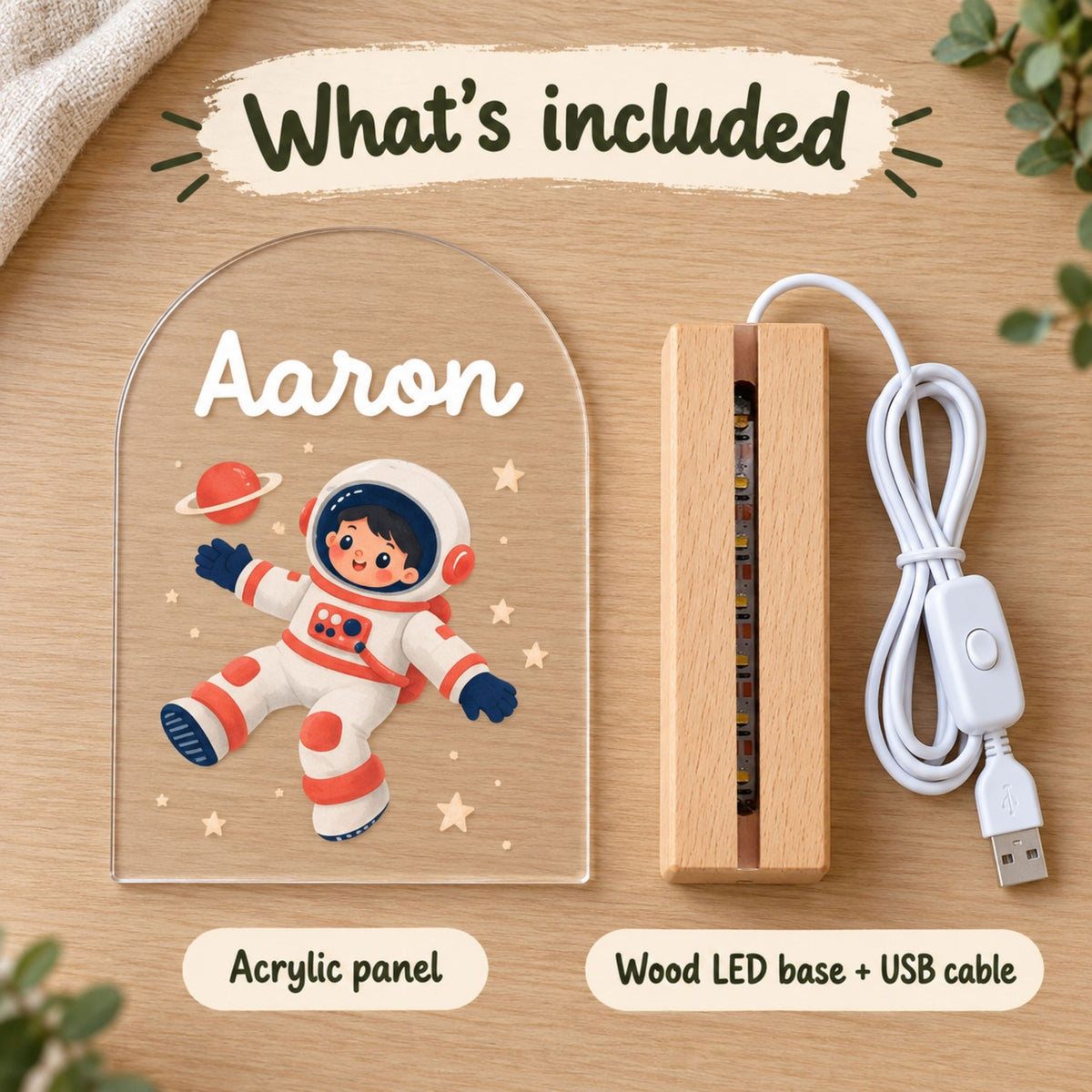 What's included graphic displays the acrylic astronaut panel, wooden LED base, and white USB cable.