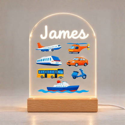 The illuminated rounded panel displays the name James above colorful transportation illustrations.