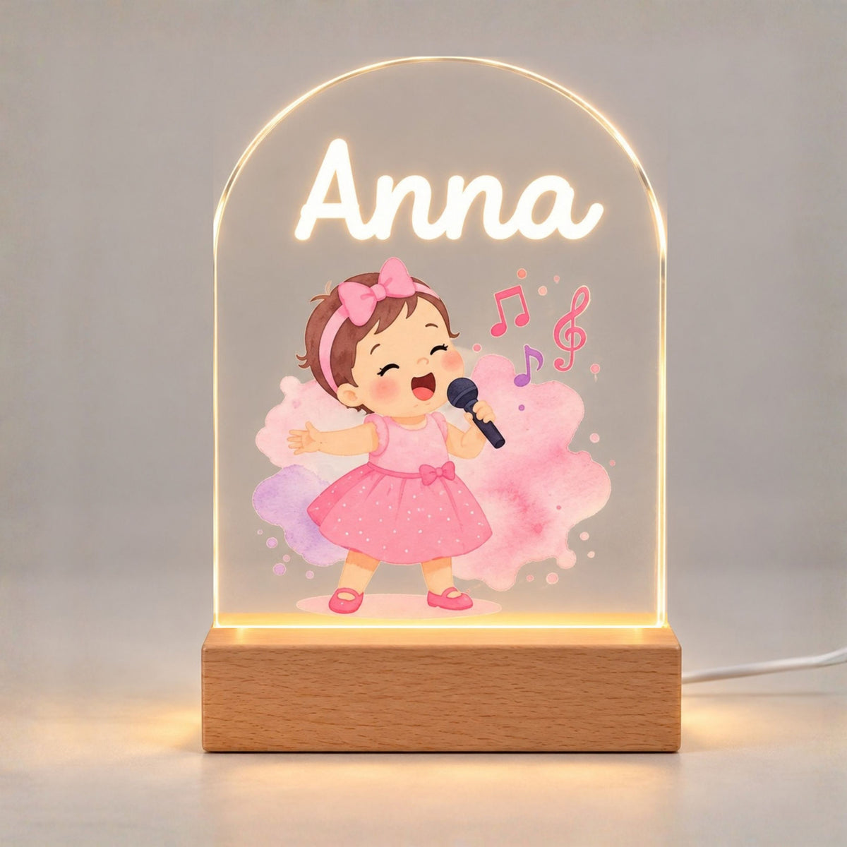 The Anna singer illustration glows warmly on a rounded acrylic panel above a rectangular base.