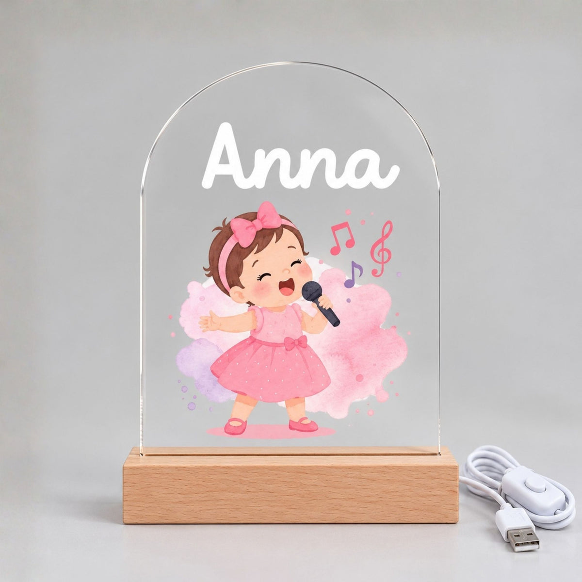 Front view of the unlit clear acrylic panel with Anna, a pink-dressed singer, and musical notes.
