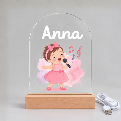 Front view of the unlit clear acrylic panel with Anna, a pink-dressed singer, and musical notes.