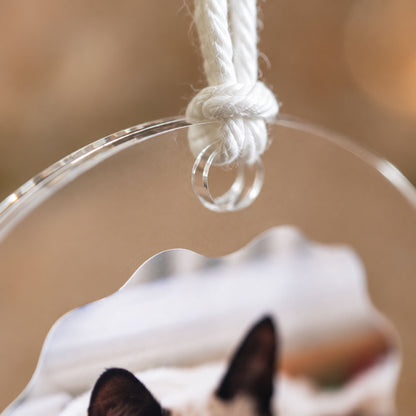 Macro detail shot of the top hanging hole and knotted white cord loop on a premium clear acrylic holiday keepsake ornament.