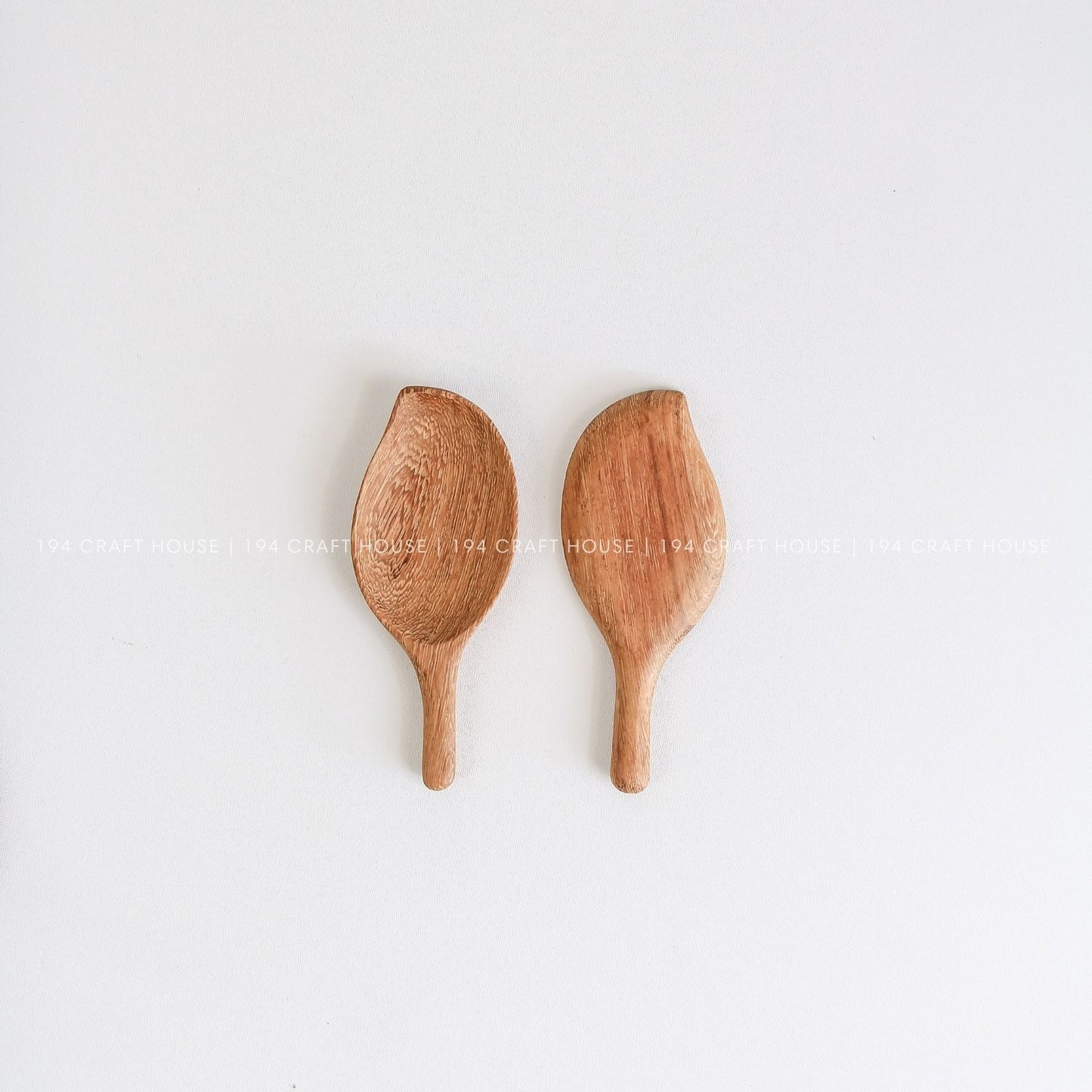 Set of two handcrafted leaf-shaped wooden measuring scoops in different sizes