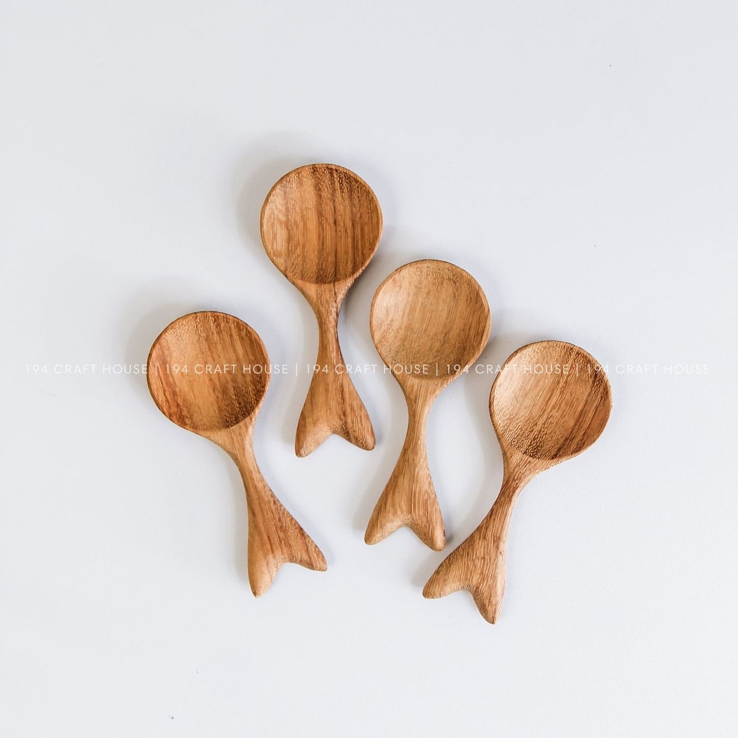 Collection of handcrafted fishtail-shaped small wooden spoons with unique natural grain variations