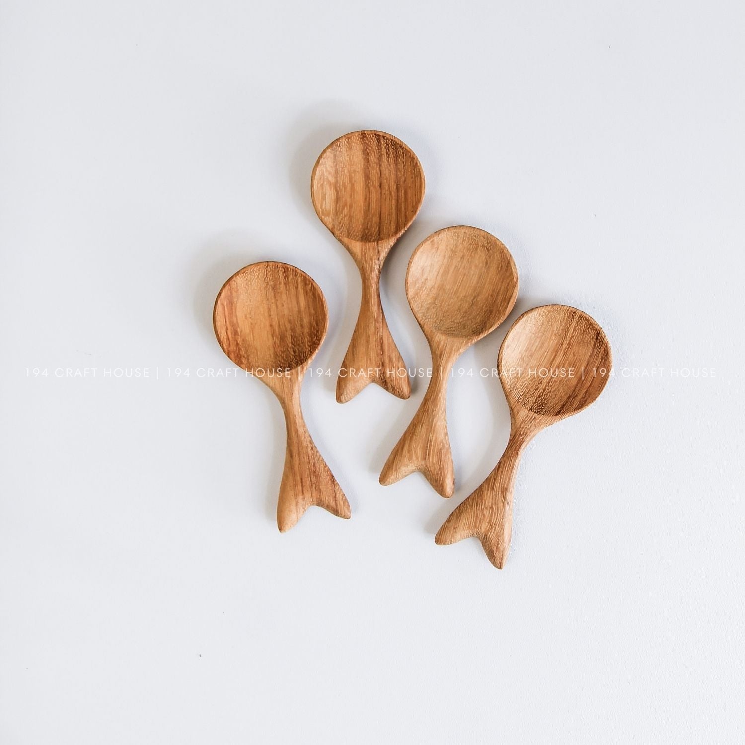 Handcrafted fishtail-shaped wooden spoons showcasing smooth finishes and natural wood grain
