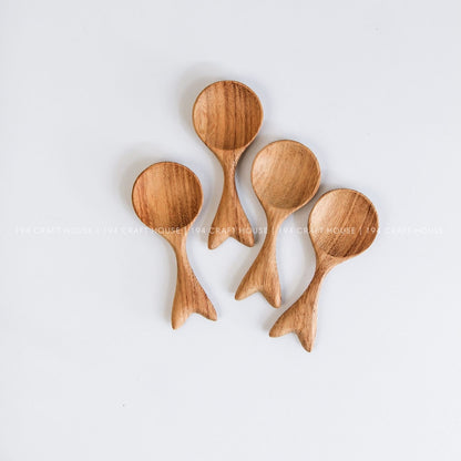 Handcrafted fishtail-shaped wooden spoons showcasing smooth finishes and natural wood grain