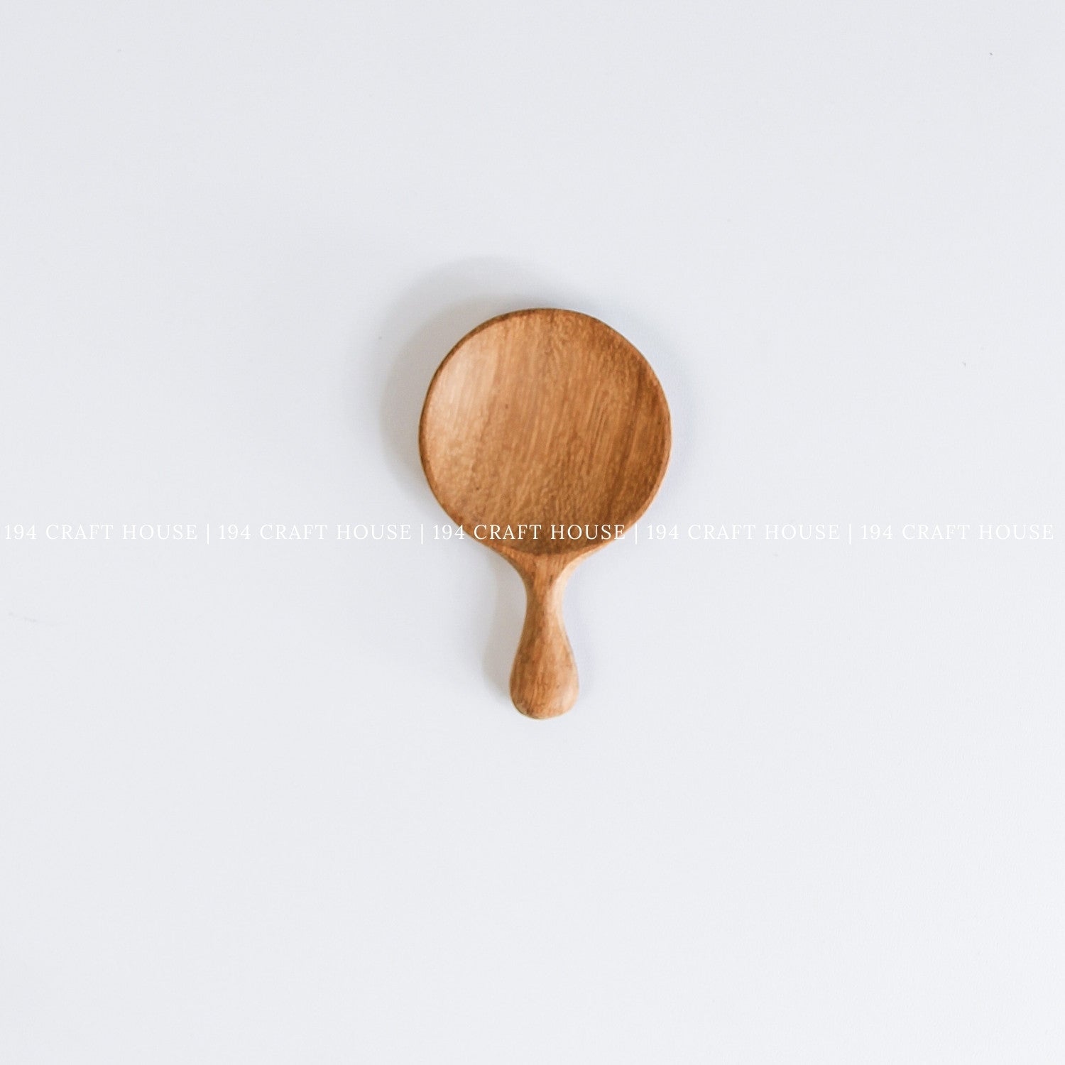 Handmade wooden tea caddy spoon with a smooth finish and natural wood grain